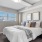 a bedroom with a bed and a plant