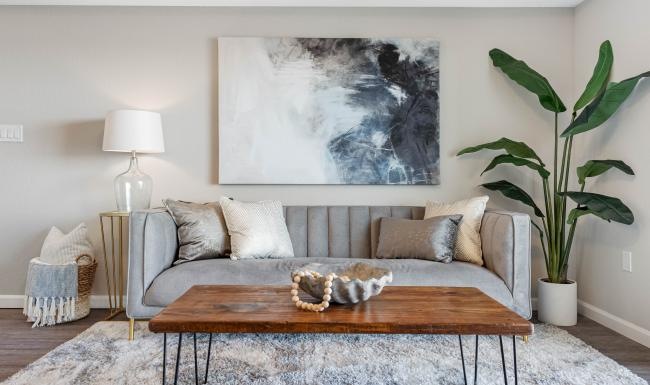 Beautiful living areas to match your lifestyle a couch with a coffee table and a painting on the wall