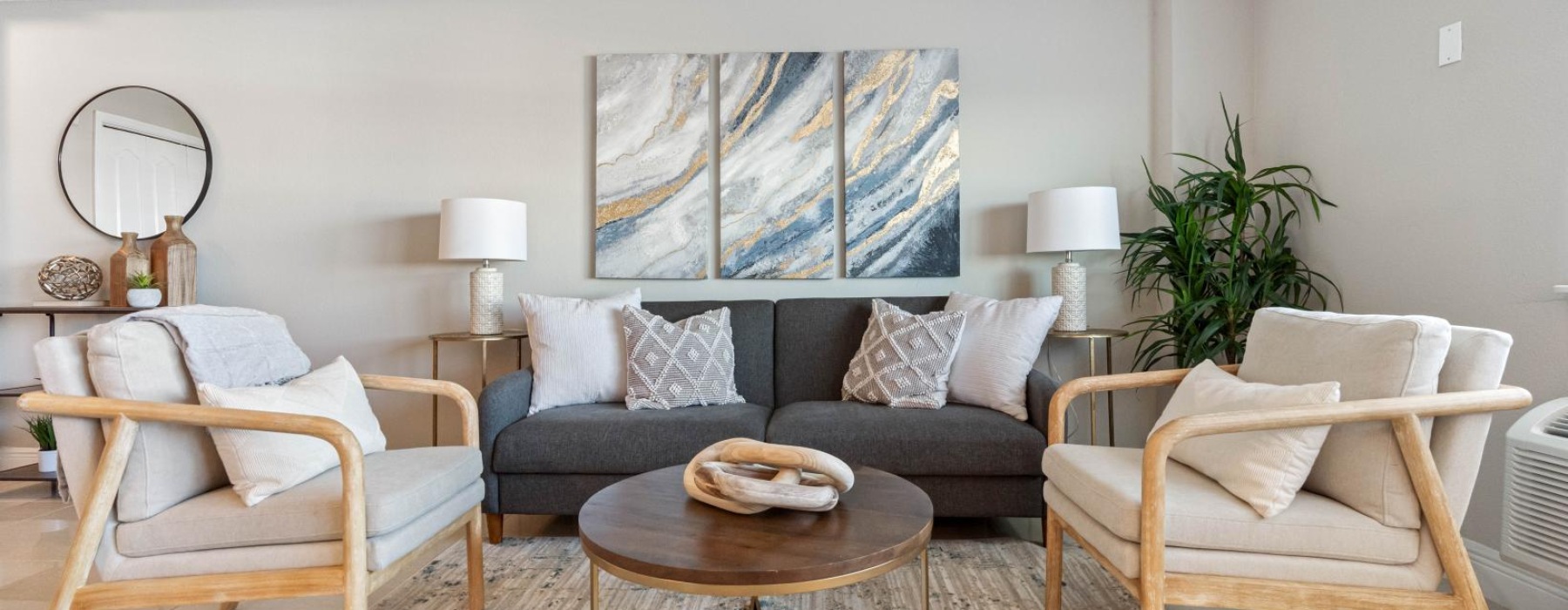 a living room with a couch and chairs