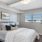 a bedroom with a bed and a plant