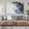 a couch with a coffee table and a painting on the wall
