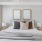 a bed with pillows and lamps